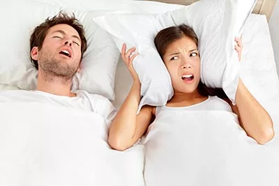 woman awake at night because of her husband's sleep apnea